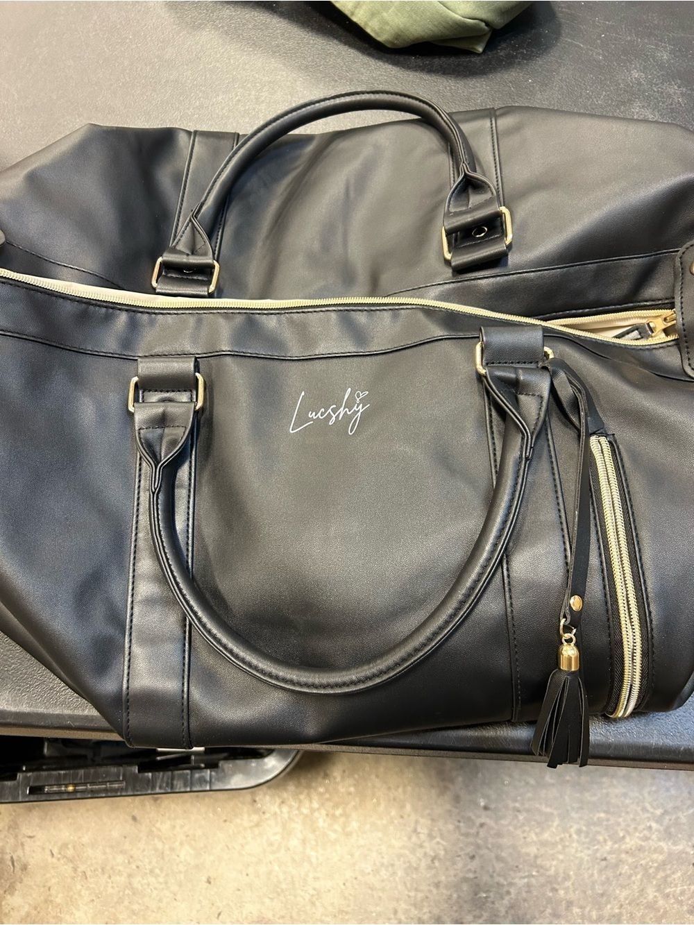 Black Lucshy Travel Tote Bag with Gold Hardware.